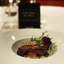 The Immigrant Restaurant signature dishes Multi-course tasting menus (e.g., "The Grand Journey"), Seared Foie Gras, Pan-Roasted Halibut, Rack of Lamb